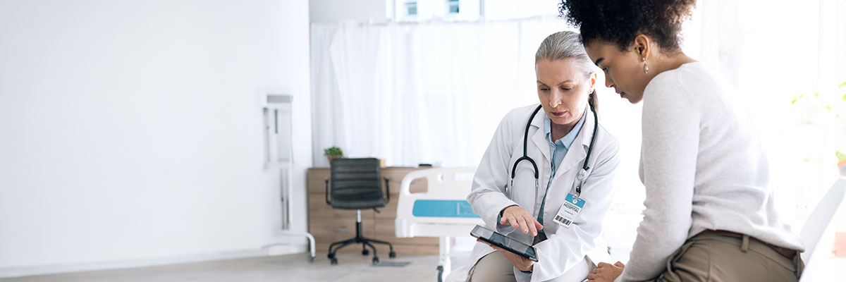Female doctor sits in consult with patient