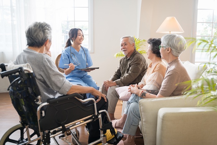 patients sit in a group with a health worker 
