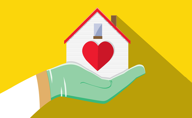 How 4 Providers Successfully Launched Hospital-at-Home Programs. The gloved hand of a clinician holds up a home with a large heart on the front of it below a window.